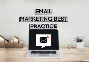 image of note reading email marketing best practice with a laptop and a plant pot and couple of other ornaments on a desk top.