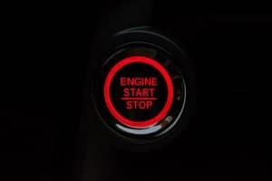 red and black car button with the words 'engine start/stop' in red for popcorn crm for small business article