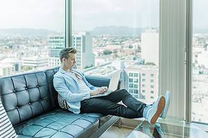 man sitting on sofa while using a laptop for simple prospecting article